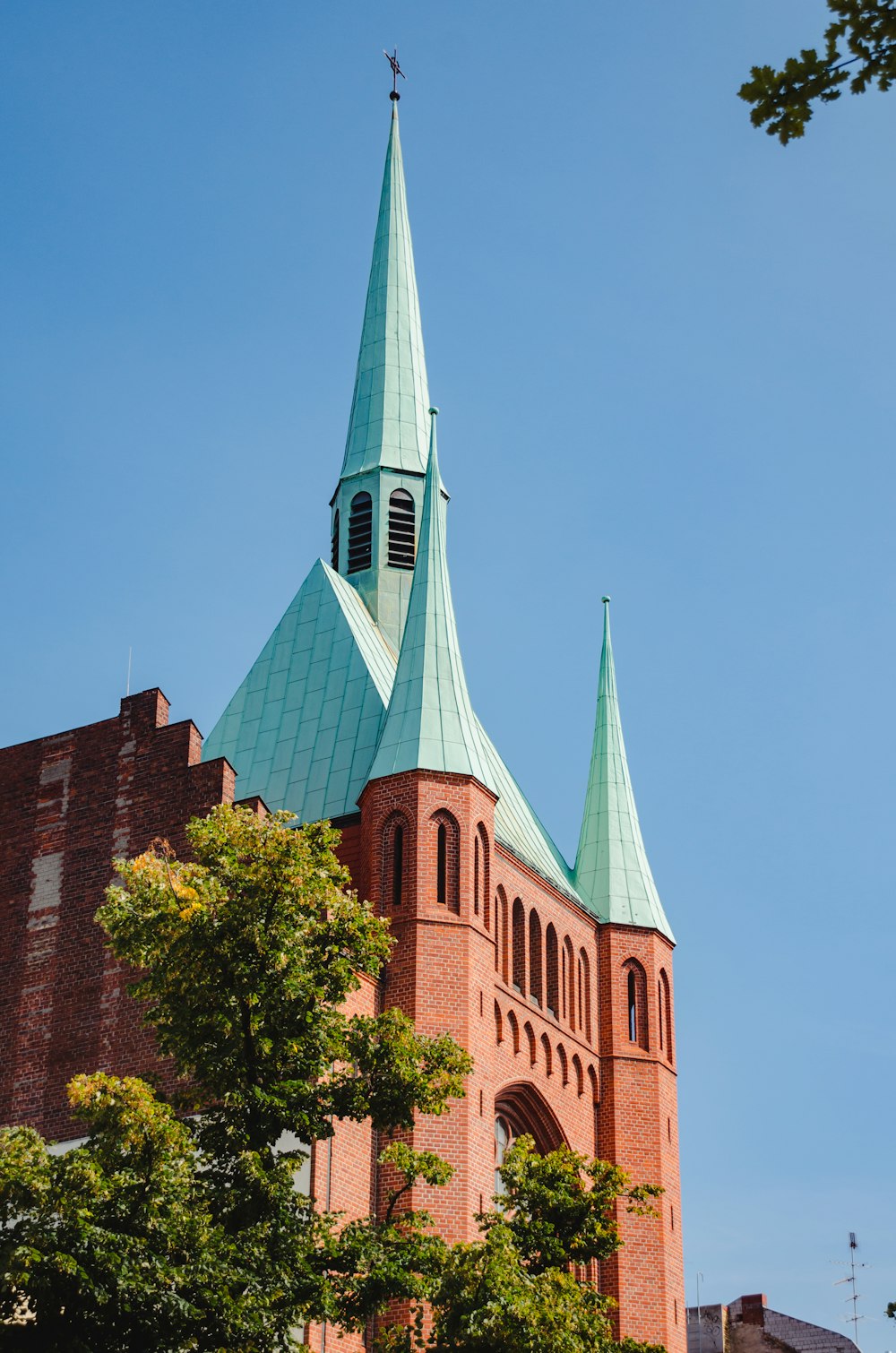 a tall building with a green steeple on top