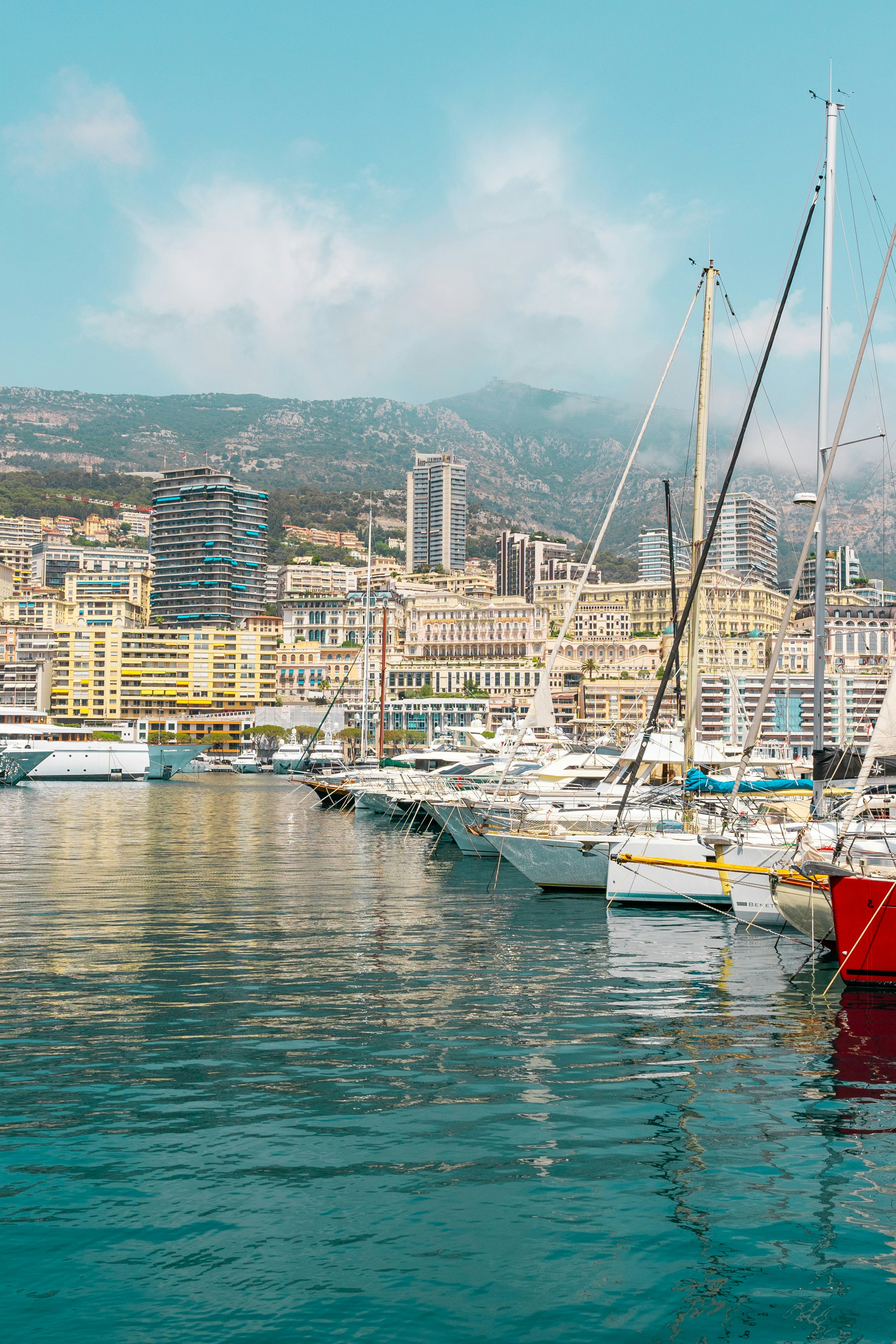 a harbor filled with lots of boats next to a city