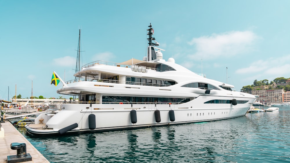 a large white boat docked at a dock