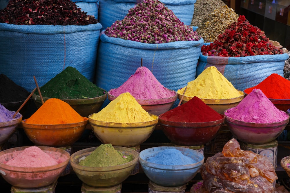 a variety of different colored powders in bowls