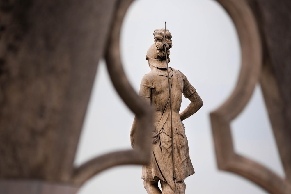 a statue of a man standing next to a sculpture of a woman