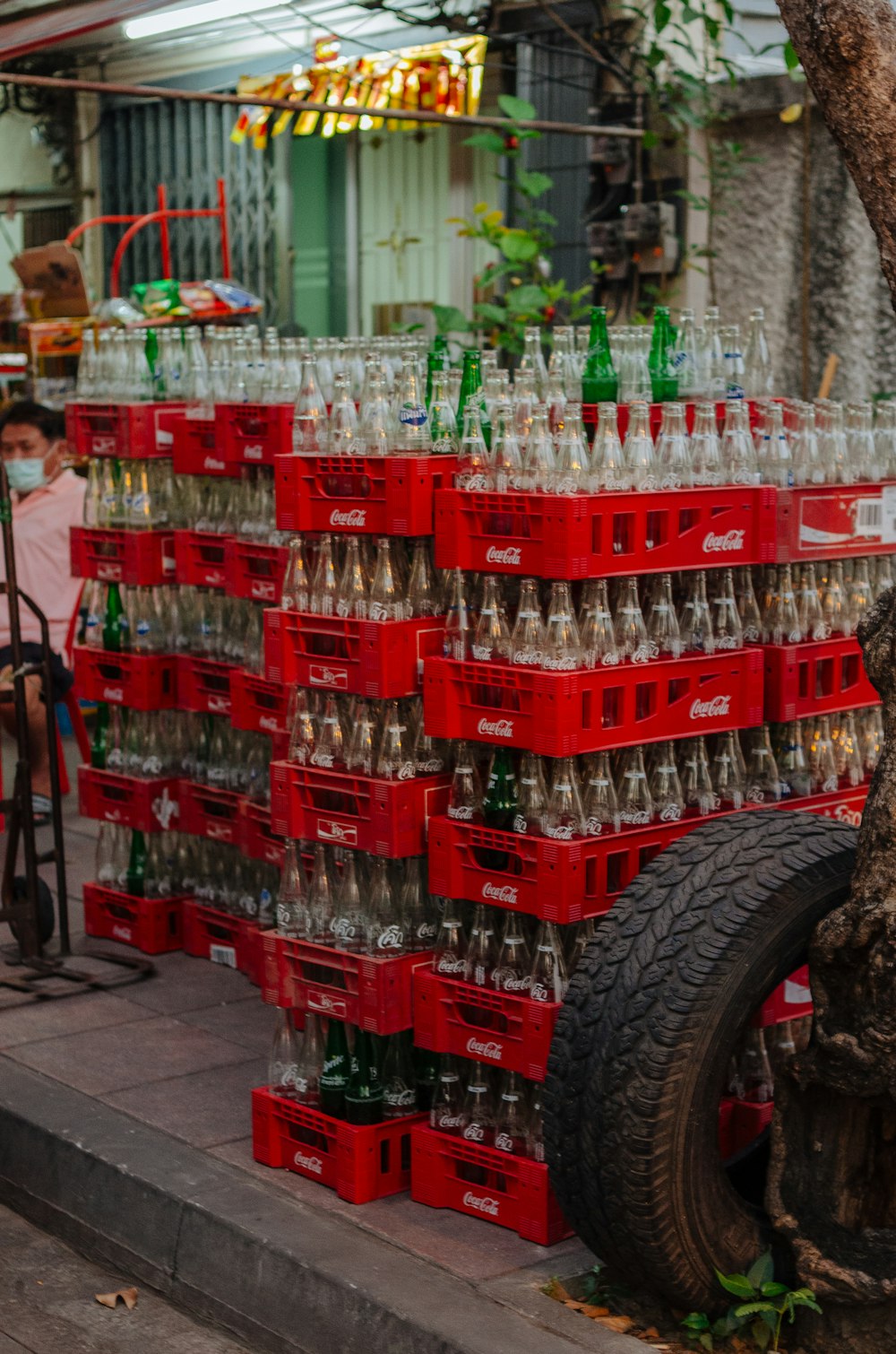 a large amount of empty bottles are stacked on top of each other