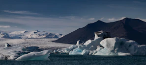 A breathtaking Antarctic iceberg under a clear blue sky, symbolizing the ultimate travel goal.