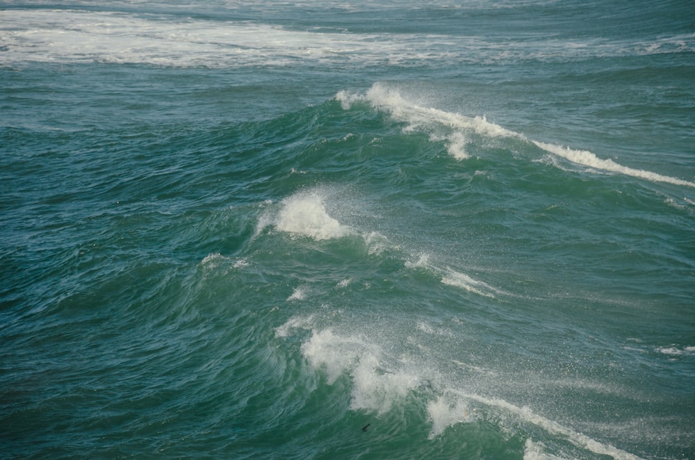 a person riding a surfboard on a wave in the ocean