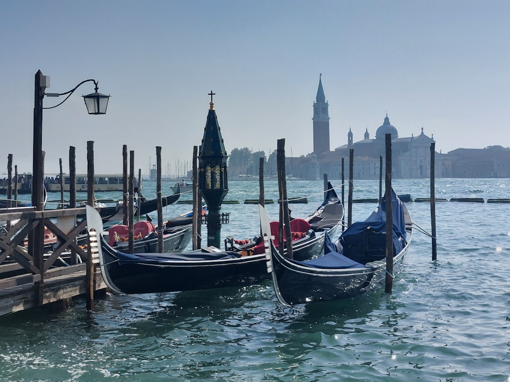 a couple of gondolas that are sitting in the water