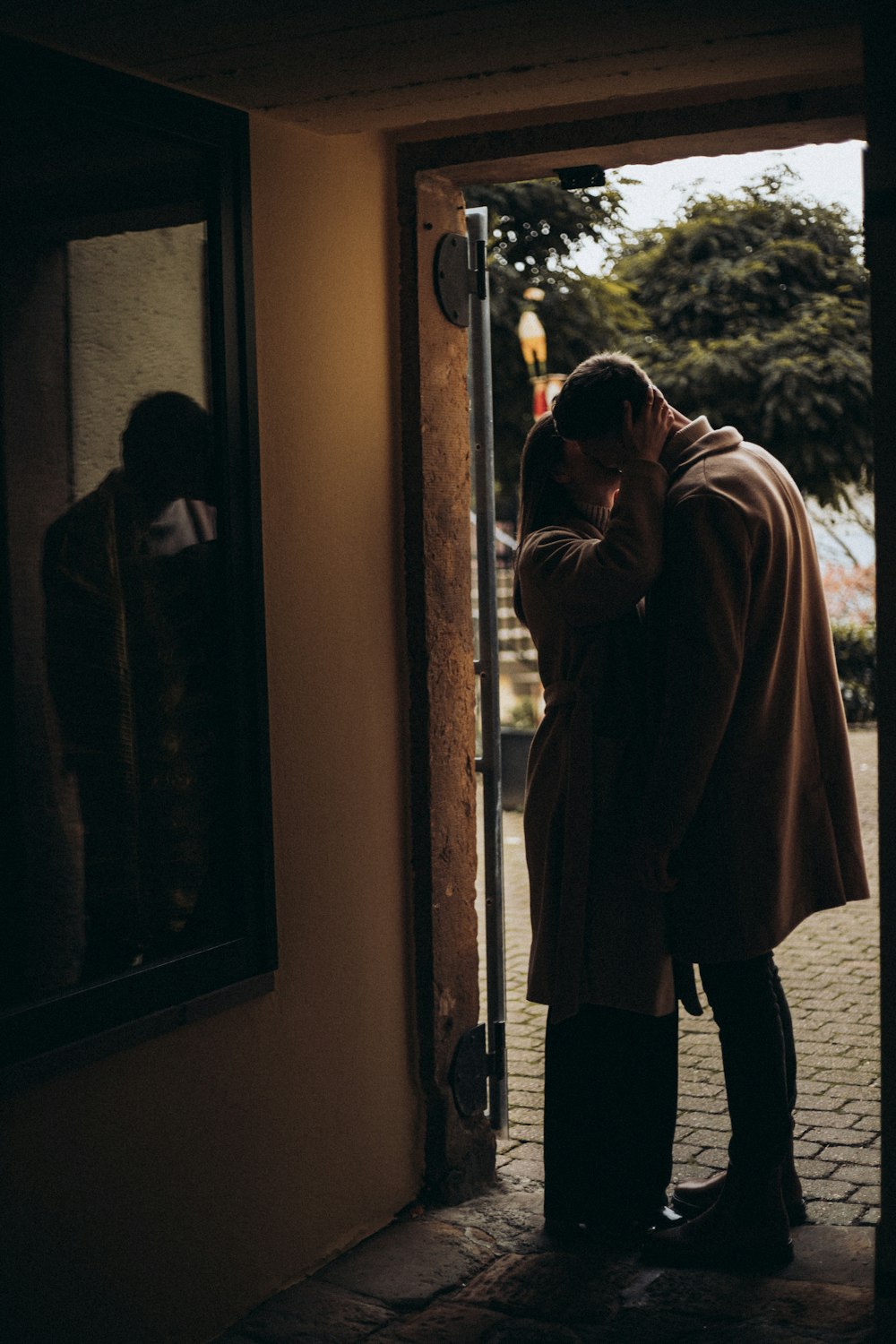 a man and a woman standing in front of a door