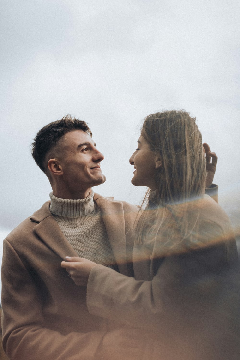 a man and a woman standing close to each other