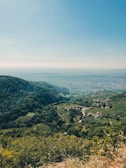 Scenic valley view with chirimoya orchards and distant mountains near Santa Rosa de Quivez.