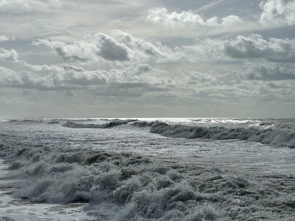 a person walking on the beach with a surfboard