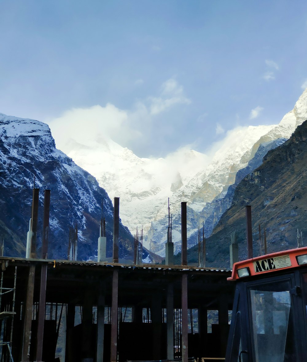 a red bus parked in front of a mountain