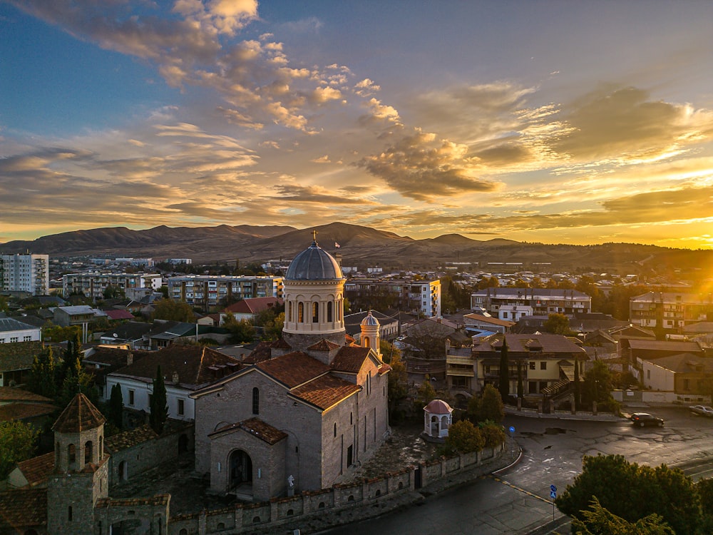 the sun is setting over a small town