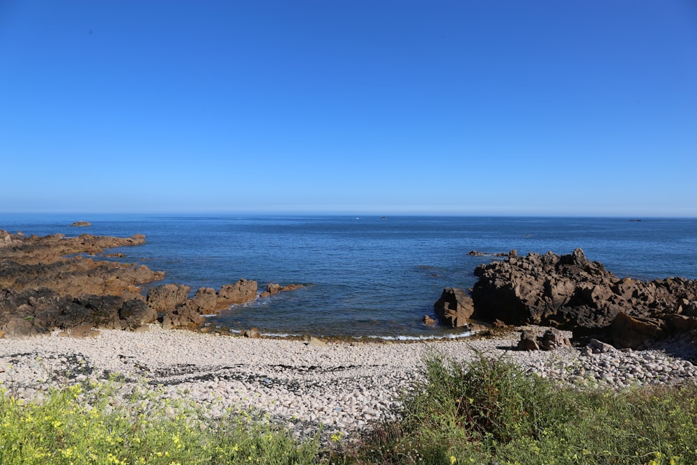 a view of the ocean from a rocky shore