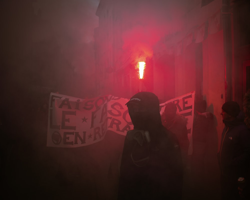 a group of people standing around a red light