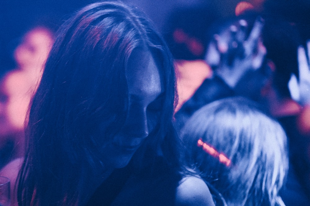 a woman standing in front of a crowd of people