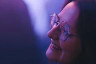 A patient smiling post-surgery, showing clear vision and relief in a softly lit recovery room.