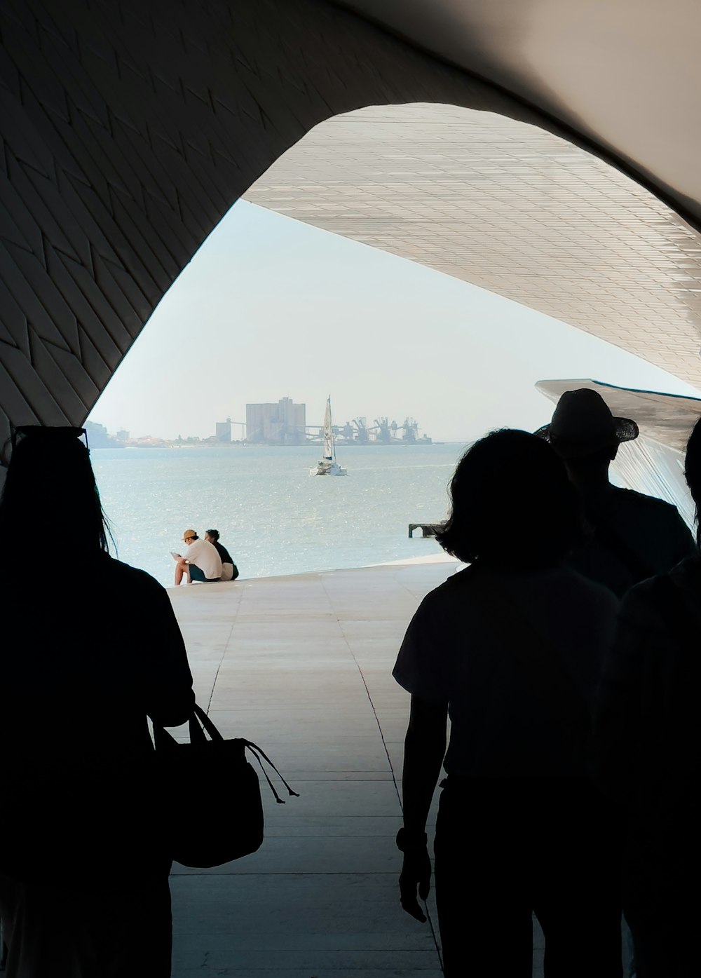 a group of people standing next to each other near a body of water