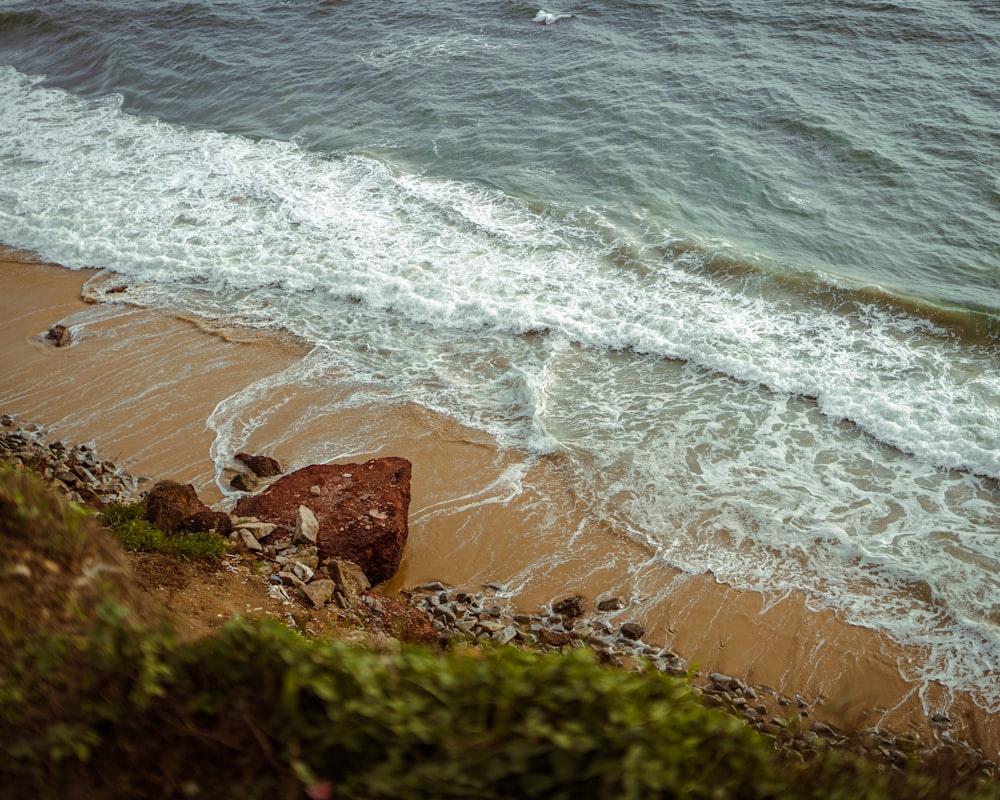 a view of a beach with waves coming in from the ocean