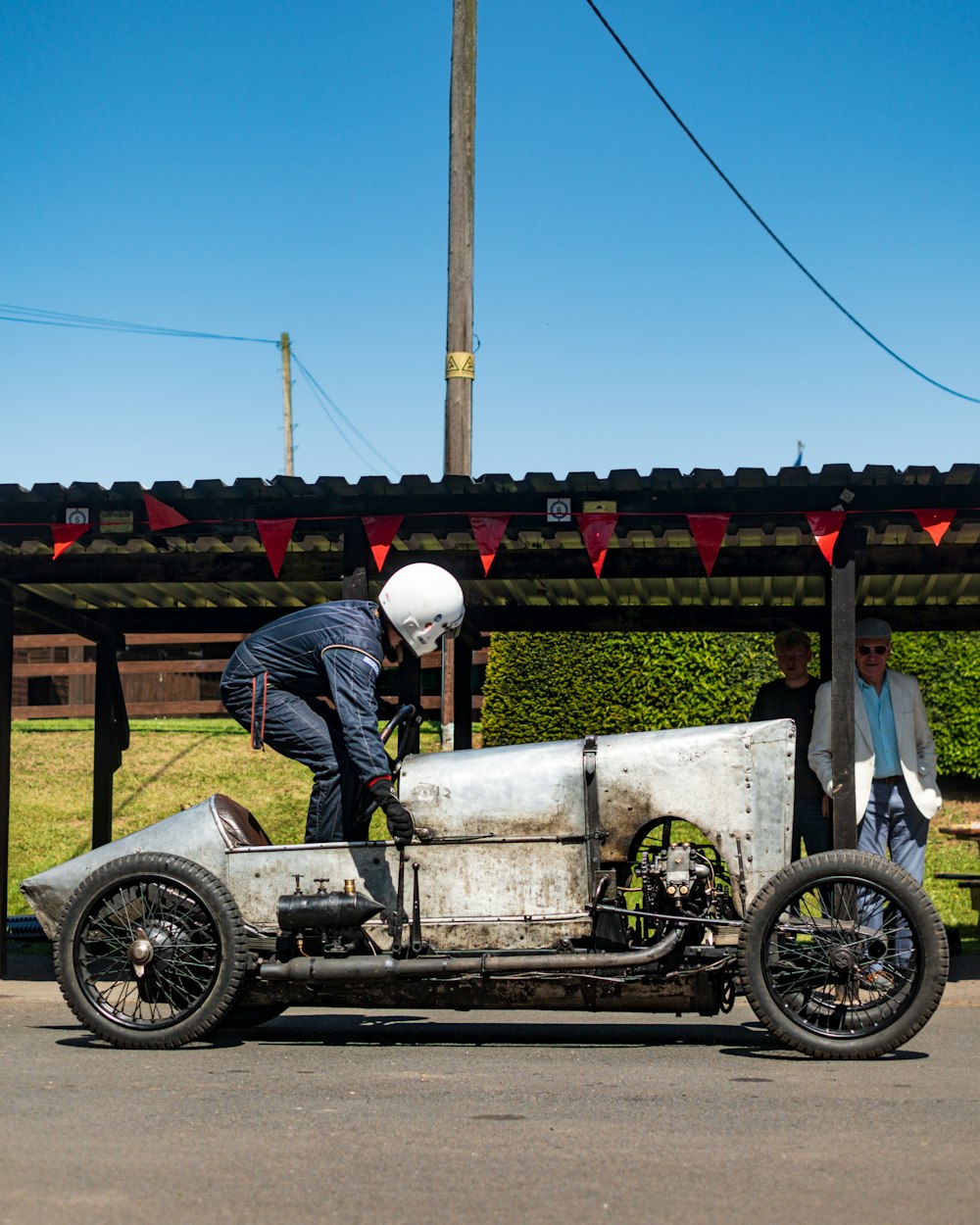 a man working on an old race car