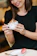 A smiling woman enjoying a creamy coffee at Zahra Luxe’s cozy hot & cold bar.