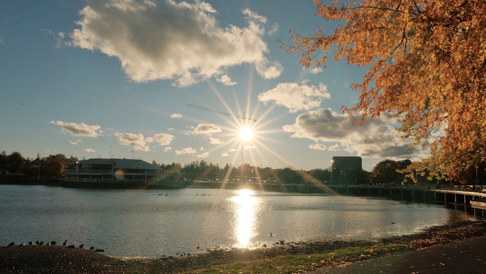 the sun is shining brightly over a lake