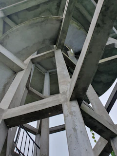 a tall metal structure with a clock on it's side