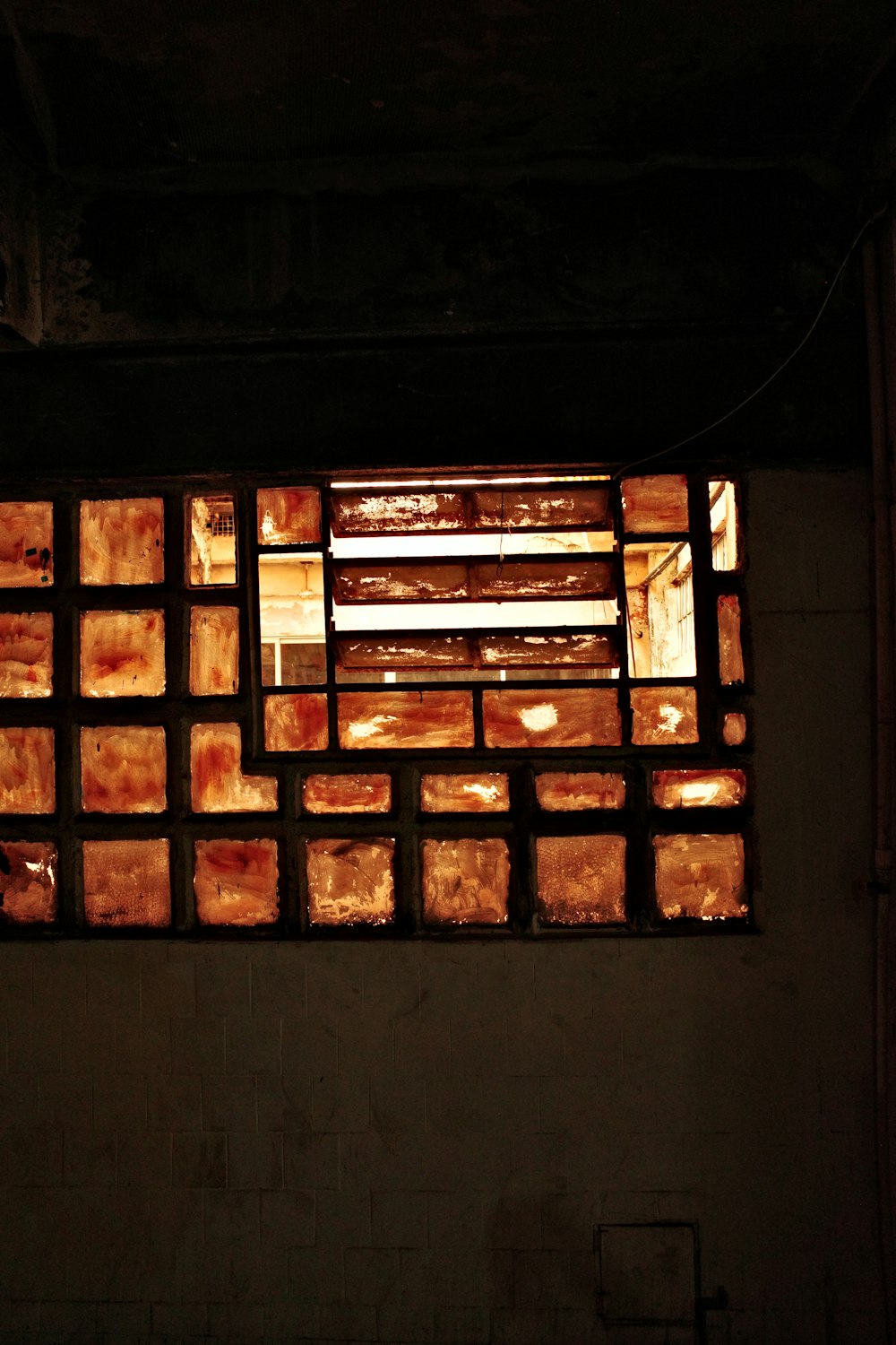 a window in a building that has a bunch of bricks in it