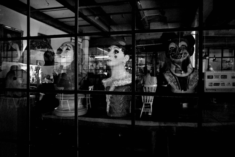 Una foto en blanco y negro de maniquíes en el escaparate de una tienda
