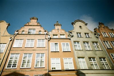 A panoramic view of a charming European street lined with colorful historic buildings under a sunny sky.