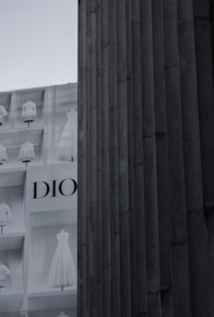 a tall building with a display of dresses on it's side