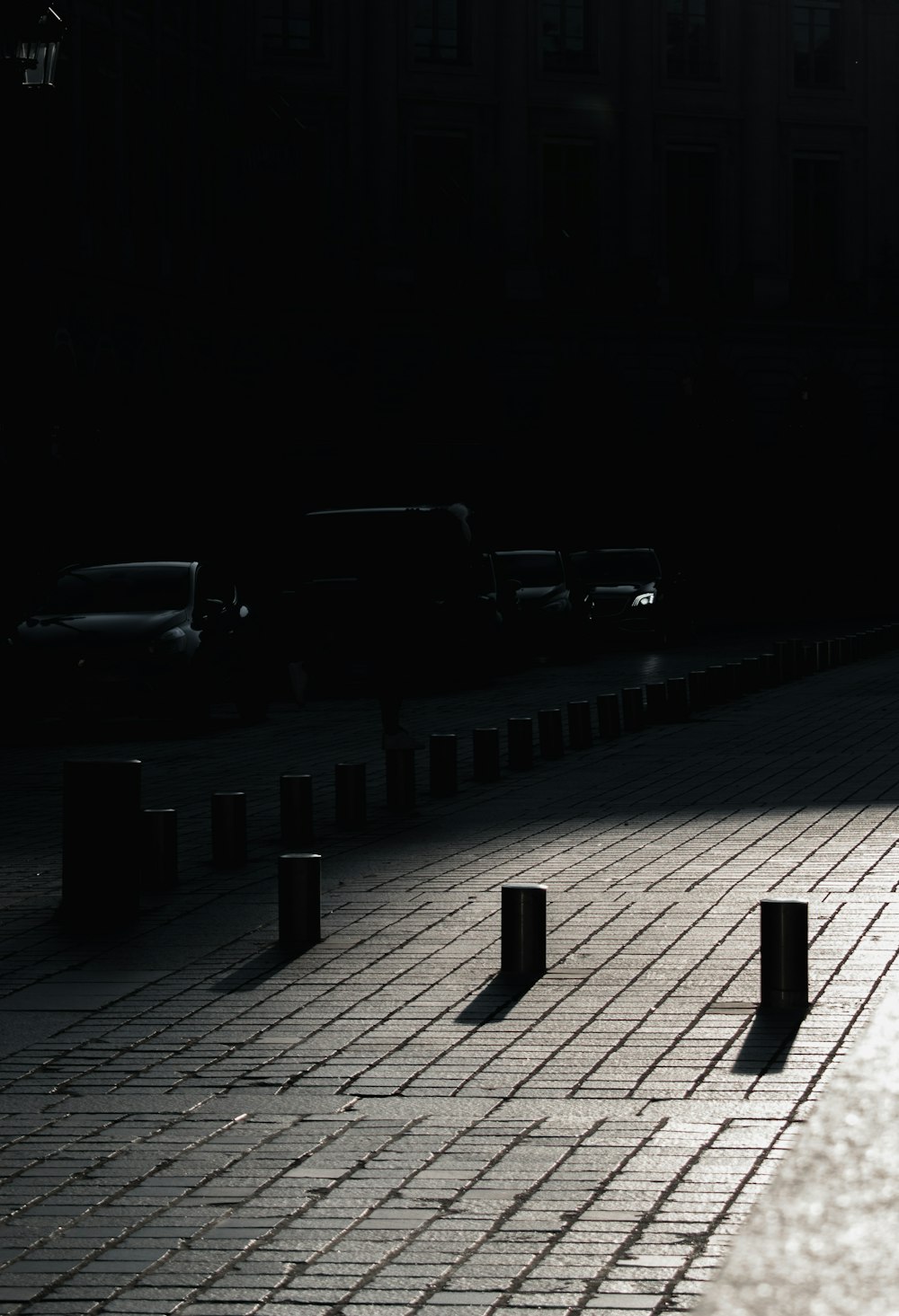 a man walking down a street next to a parking meter