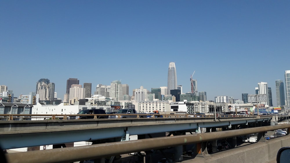 a freeway with a lot of traffic and tall buildings in the background
