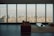 A modern living room with elegant furniture and large windows showcasing a beautiful view.