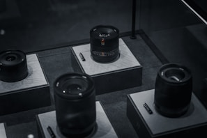 High-end camera lenses arranged neatly on a modern display table.