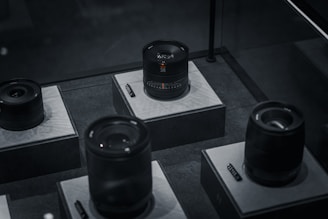 High-end camera lenses arranged neatly on a modern display table.