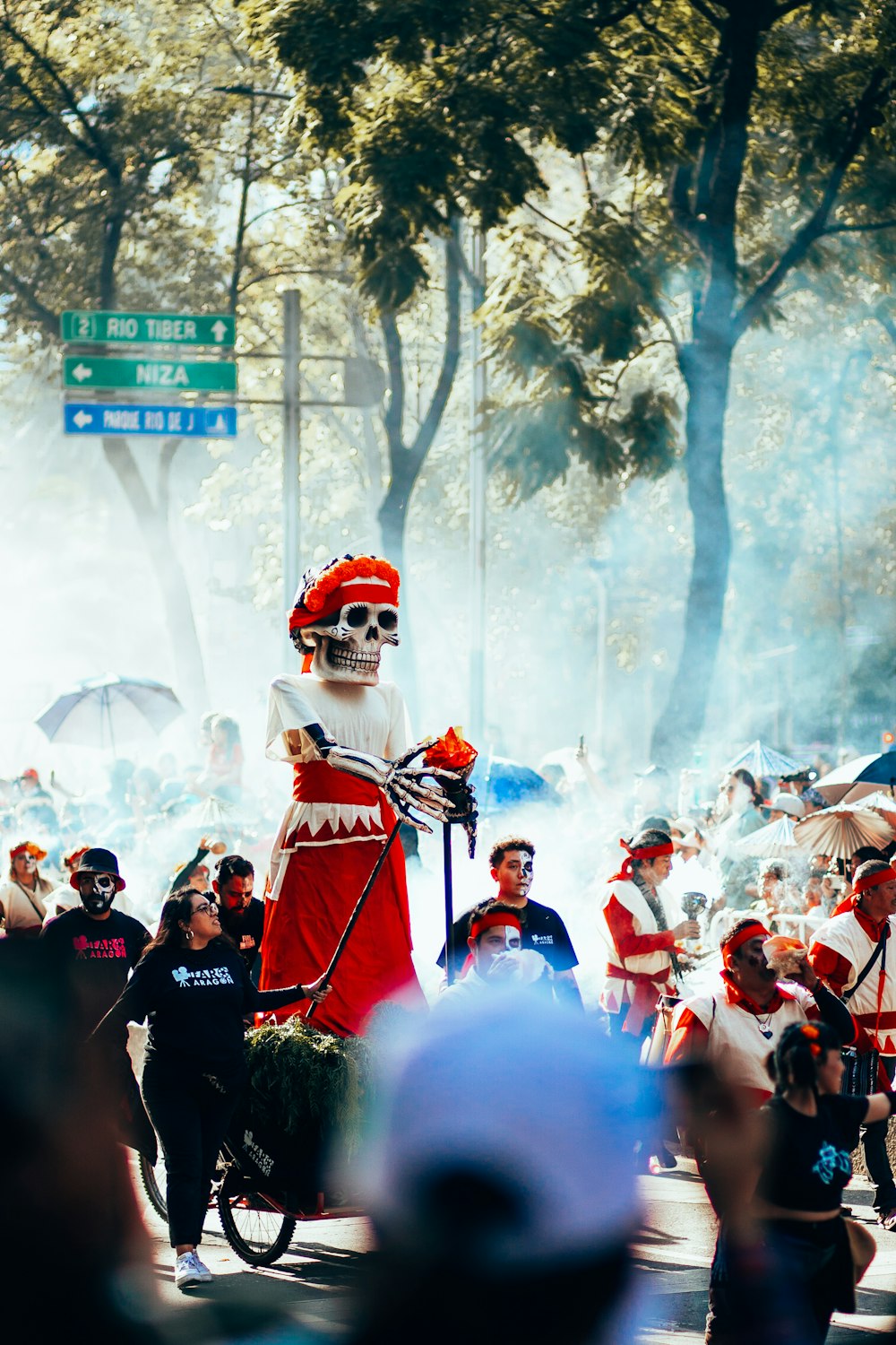 a group of people standing around a man in a skeleton costume