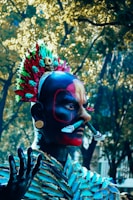 Close-up of a character with striking makeup and bold costume reflecting the epic narrative.