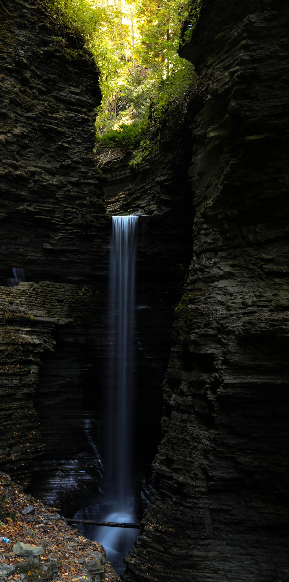 a waterfall in the middle of a canyon