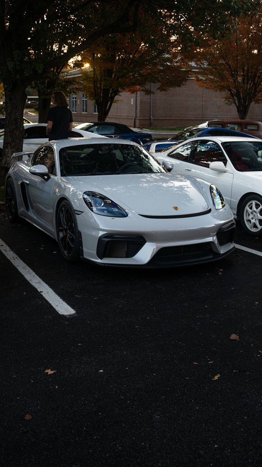 two white sports cars parked in a parking lot