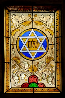 a stained glass window with a star of david on it