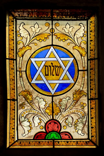 a stained glass window with a star of david on it