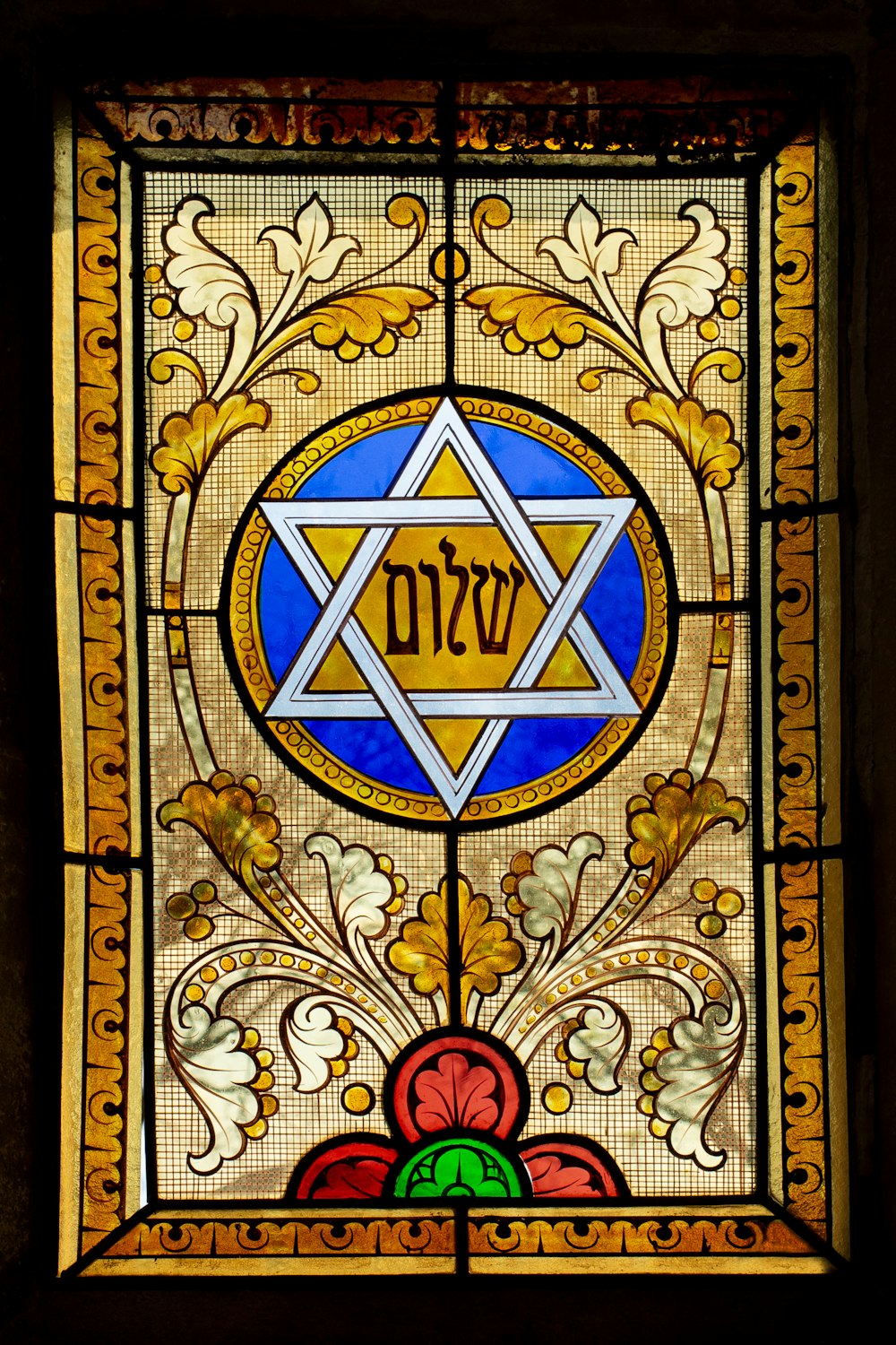 a stained glass window with a star of david on it