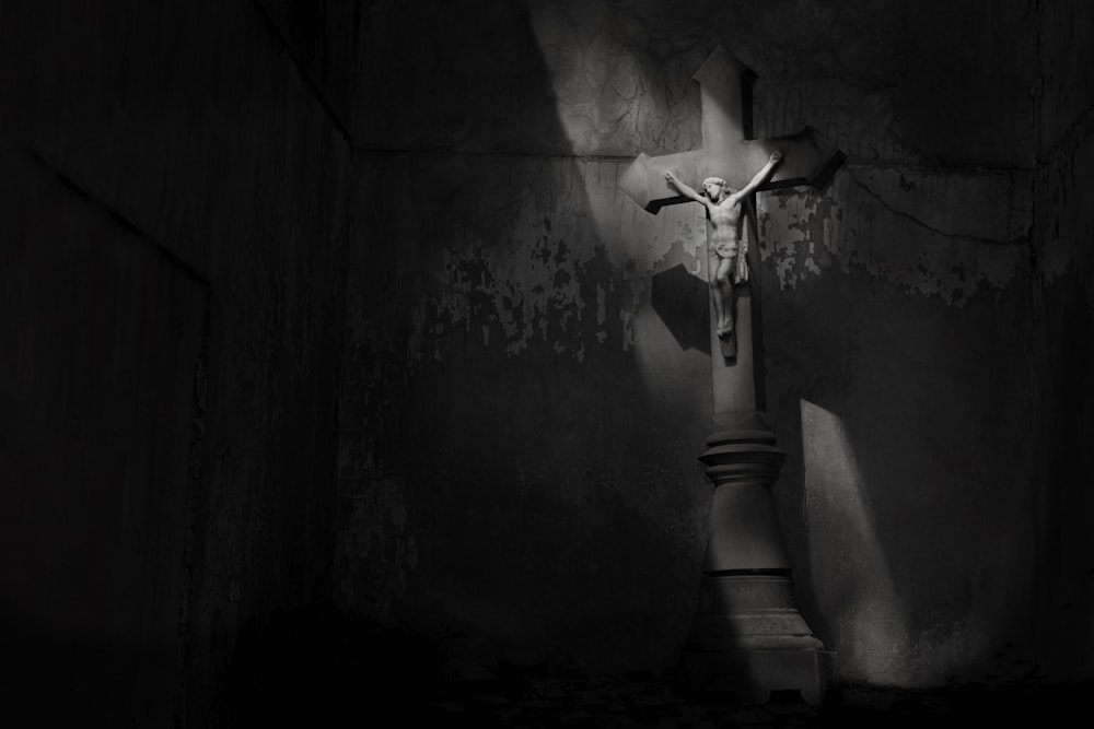 a crucifix in the corner of a dark room
