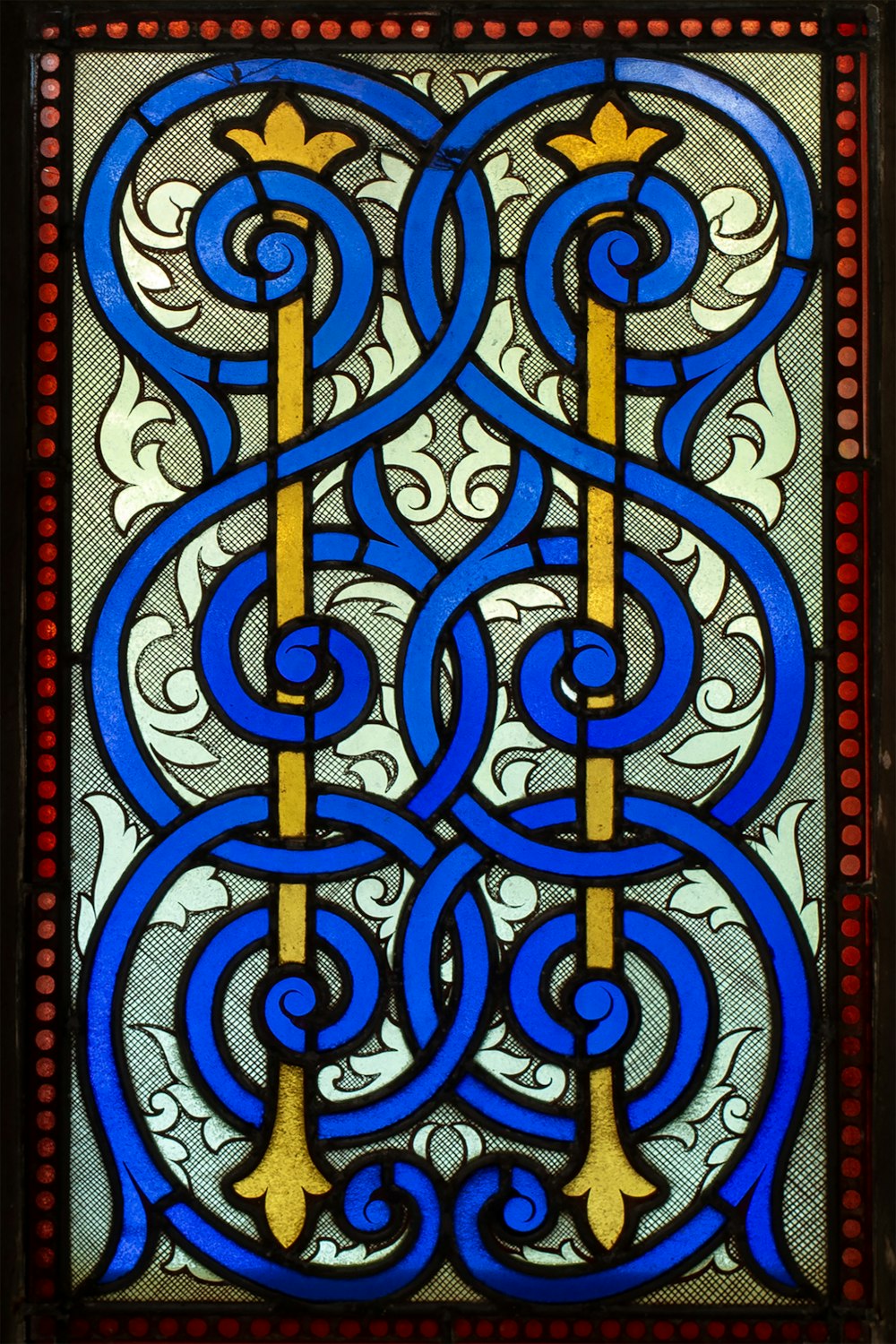a stained glass window with a design on it