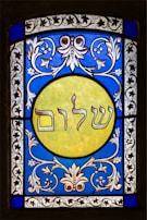 A printed synagogue flyer with clear RSVP details and a tasteful border inspired by traditional motifs.