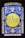 A stained glass window featuring elaborate floral patterns in blue and white surrounding a central yellow circle. Inside the circle, Hebrew text is prominently displayed. The design exhibits detailed craftsmanship with symmetrical motifs.