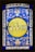 A stained glass window featuring elaborate floral patterns in blue and white surrounding a central yellow circle. Inside the circle, Hebrew text is prominently displayed. The design exhibits detailed craftsmanship with symmetrical motifs.