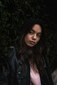 a woman in a black leather jacket posing for a picture