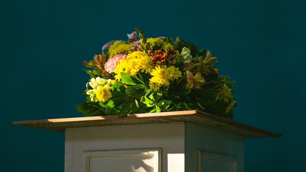 a bunch of flowers sitting on top of a table