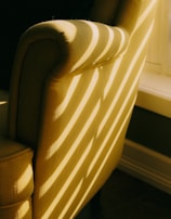 Spotless upholstery on a chair with sunlight streaming through a nearby window.