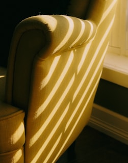 Spotless upholstery on a chair with sunlight streaming through a nearby window.